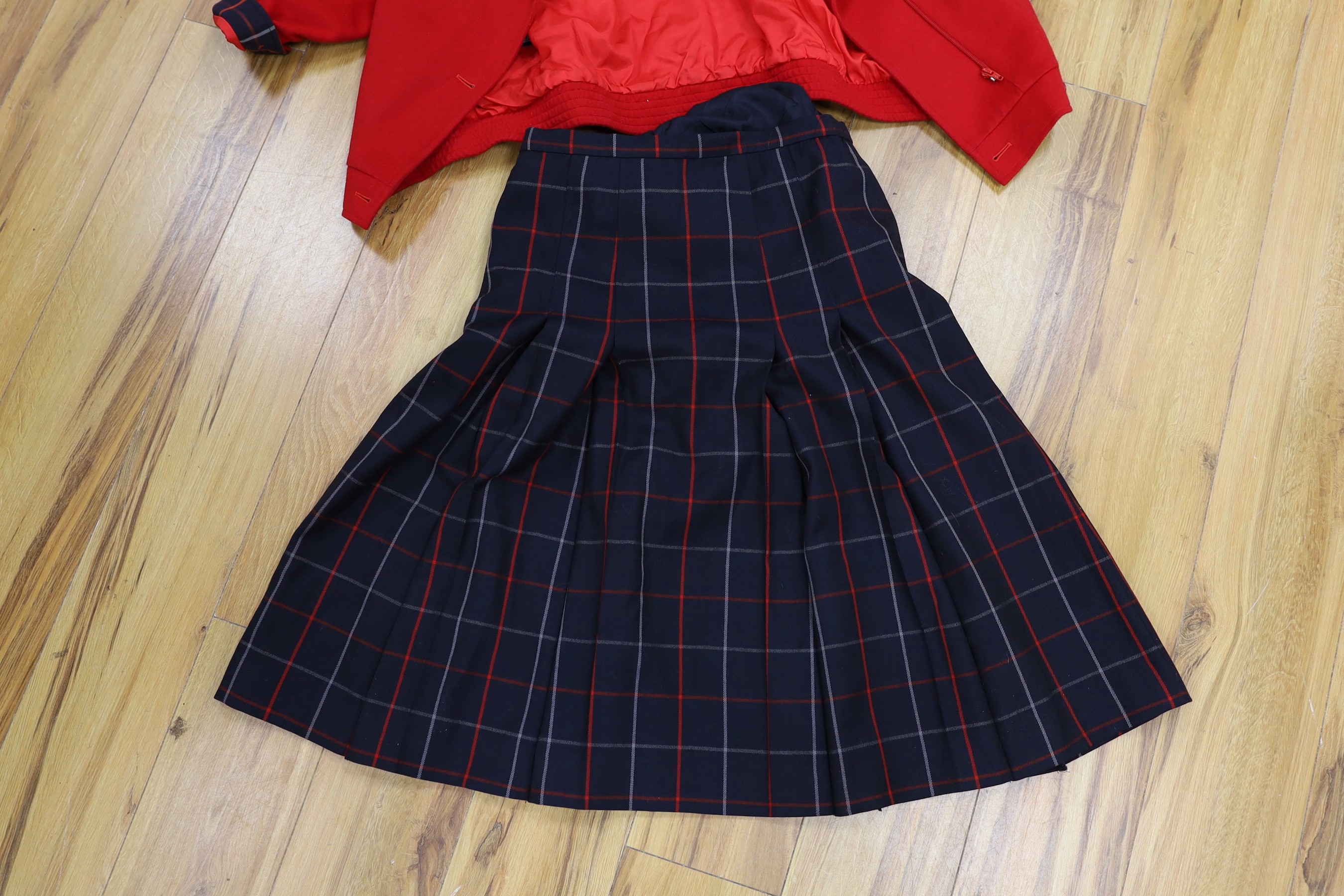 Two vintage Burberry items of clothing: a pleated skirt and a red Harrington jacket